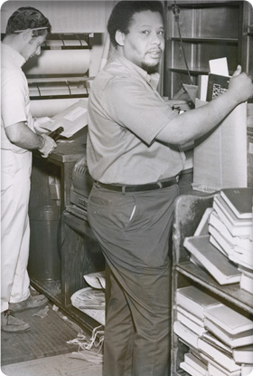 Two staff processing books for interlibrary loan